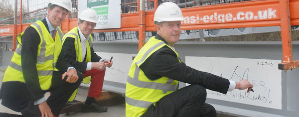 Nick Boles signing a construction beam of 2 Glass Wharf, Bristol